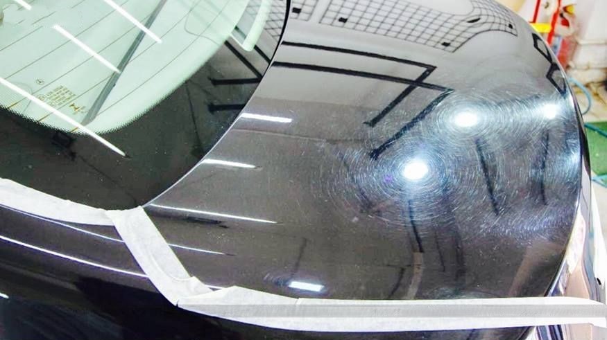 Before paint correction — swirl marks and fine scratches on black paint